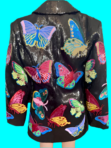 Black sequin jacket with colorful butterfly patterns on a glittery background